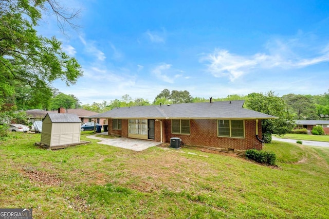 3050 Rebecca Dr SW, Atlanta, GA 30311 - back of house featuring a shed, a yard, a patio, and brick siding