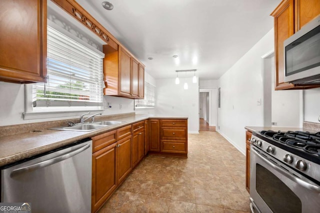 3050 Rebecca Dr SW, Atlanta, GA 30311 - kitchen with appliances with stainless steel finishes, plenty of natural light, brown cabinetry, and hanging light fixtures