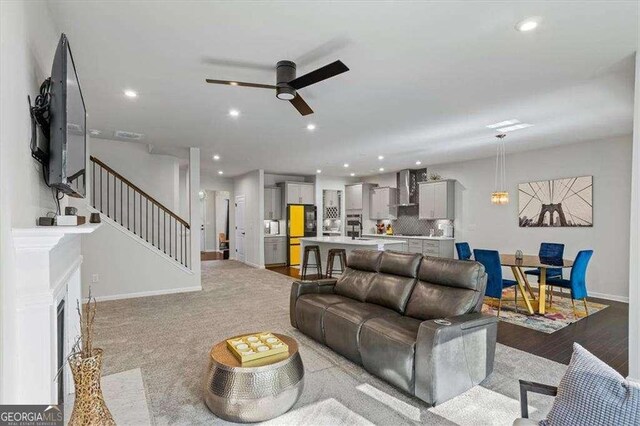 312 Wichita Way, Mcdonough, GA 30253 - living area with a fireplace with flush hearth, baseboards, recessed lighting, stairway, and ceiling fan
