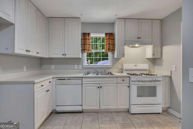 kitchen featuring white cabinets, a sink, white appliances, light countertops, and under cabinet range hood