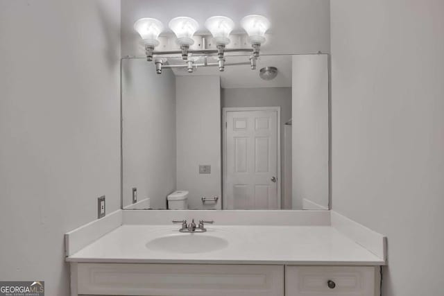 bathroom featuring toilet and vanity