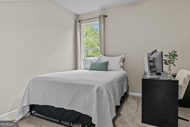 carpeted bedroom featuring baseboards