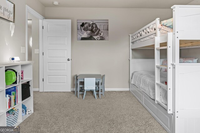carpeted bedroom featuring baseboards