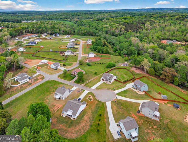 bird's eye view with a residential view and a wooded view
