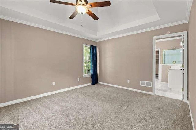 unfurnished room featuring a ceiling fan, visible vents, carpet floors, and a raised ceiling