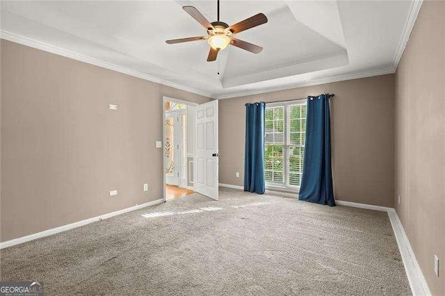 spare room featuring a ceiling fan, baseboards, carpet, and ornamental molding