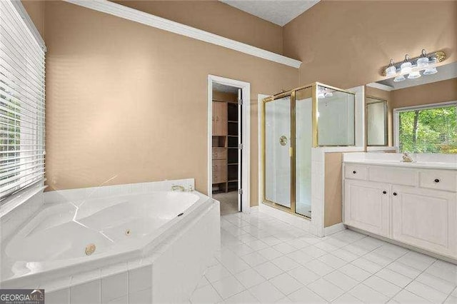 bathroom featuring a jetted tub, tile patterned flooring, vanity, and a stall shower