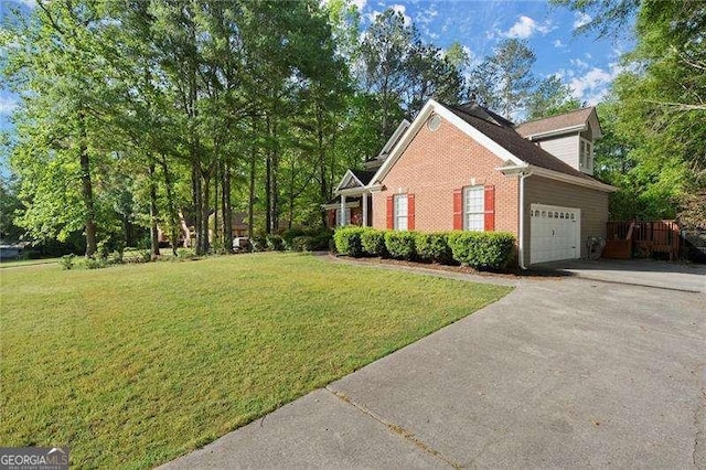 view of side of home featuring brick siding, a yard, an attached garage, and driveway