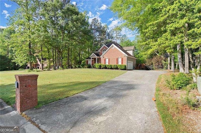 traditional-style house with an attached garage, driveway, and a front yard