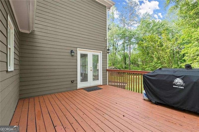 wooden deck featuring french doors and a grill