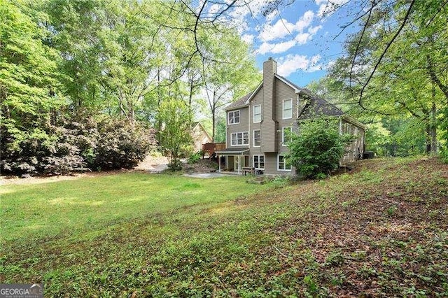 exterior space with a lawn and a chimney