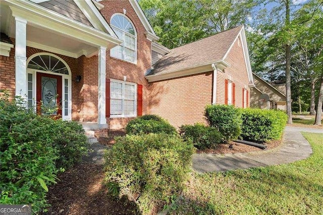 view of side of property featuring brick siding