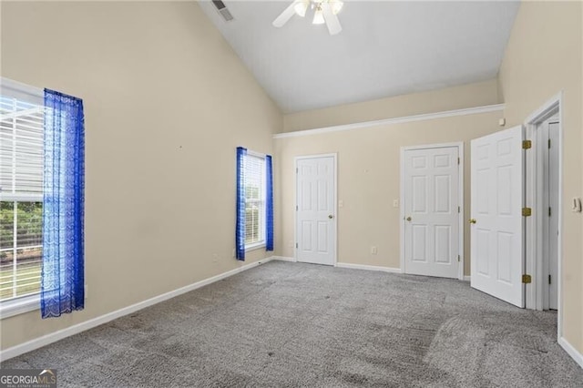 unfurnished bedroom with ceiling fan, visible vents, high vaulted ceiling, baseboards, and carpet flooring