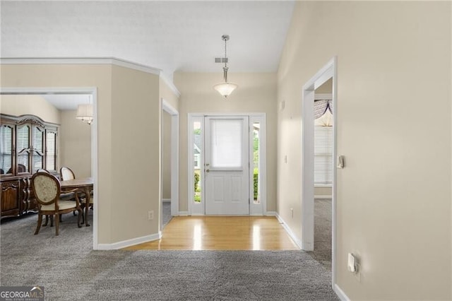 carpeted entryway featuring baseboards, visible vents, and a healthy amount of sunlight