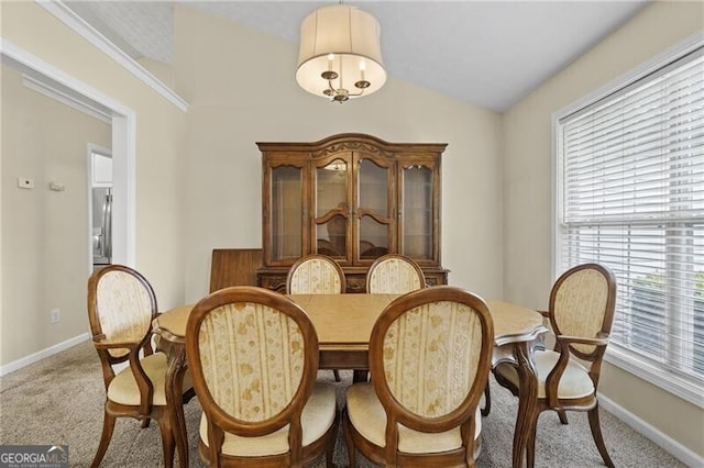 dining space featuring a healthy amount of sunlight, baseboards, and light carpet