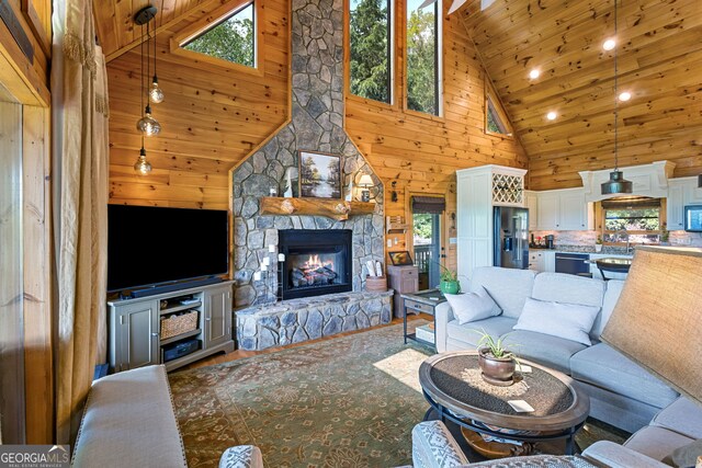 living room with high vaulted ceiling, a healthy amount of sunlight, and wood ceiling