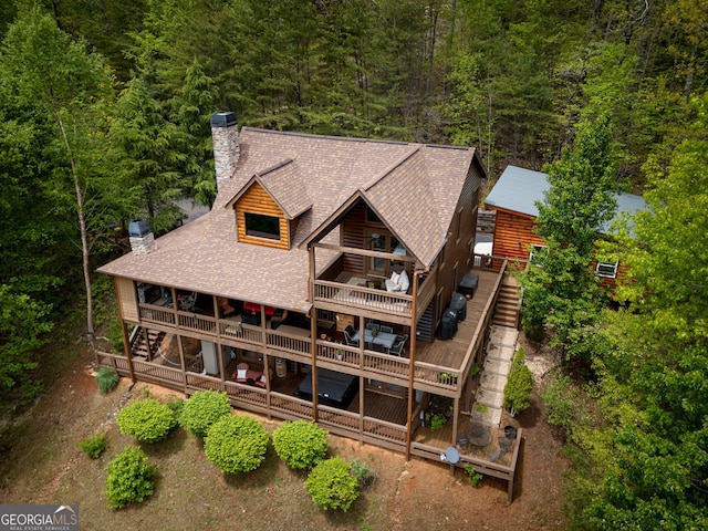 birds eye view of property featuring a view of trees
