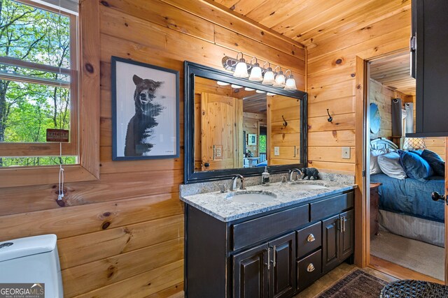 bathroom with wood walls and a sink