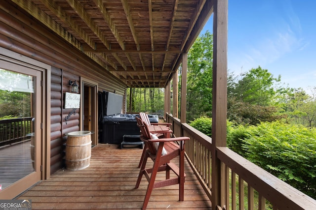wooden deck with a hot tub