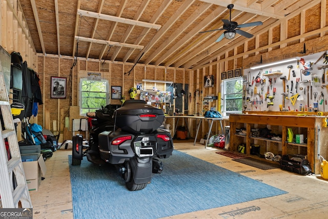 garage with a workshop area and a ceiling fan