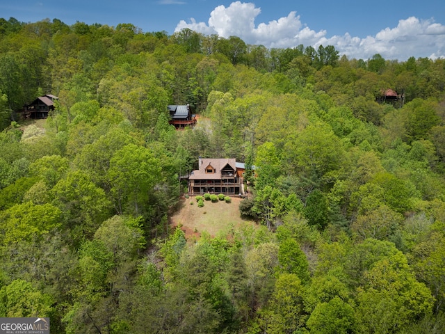 birds eye view of property featuring a wooded view