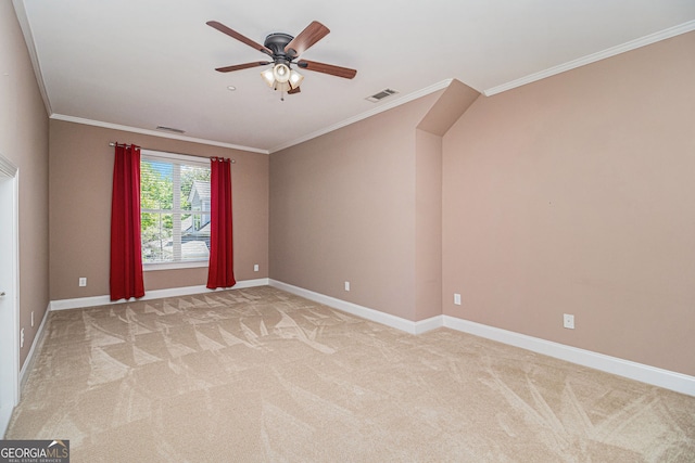 unfurnished room featuring ornamental molding, light carpet, a ceiling fan, and baseboards