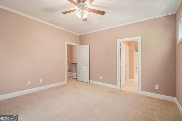 unfurnished bedroom featuring ornamental molding, light colored carpet, baseboards, ensuite bathroom, and a ceiling fan