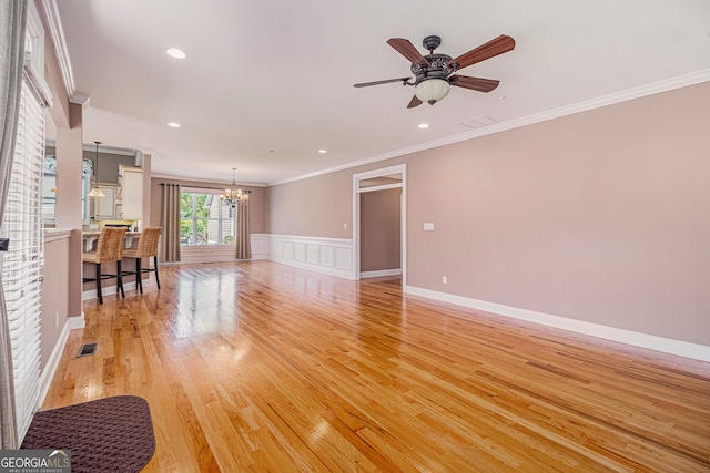 living room featuring a chandelier, ornamental molding, light wood-style floors, ceiling fan, and recessed lighting