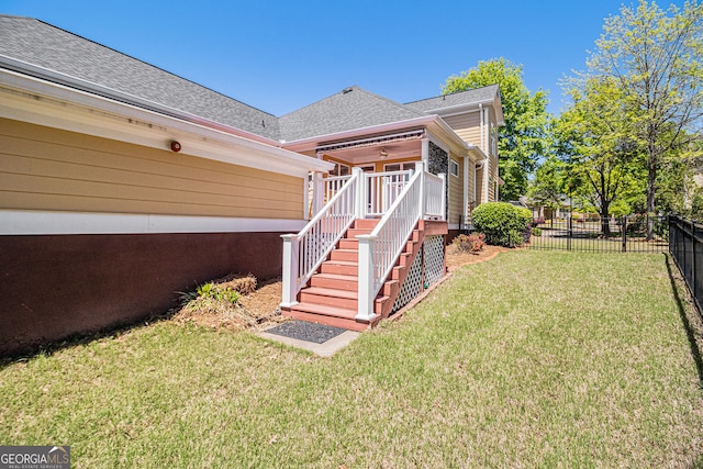 rear view of property featuring a shingled roof