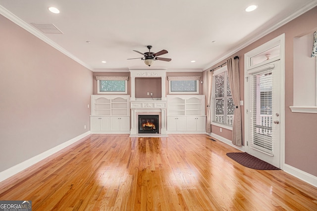 unfurnished living room featuring light wood finished floors, crown molding, ceiling fan, baseboards, and recessed lighting