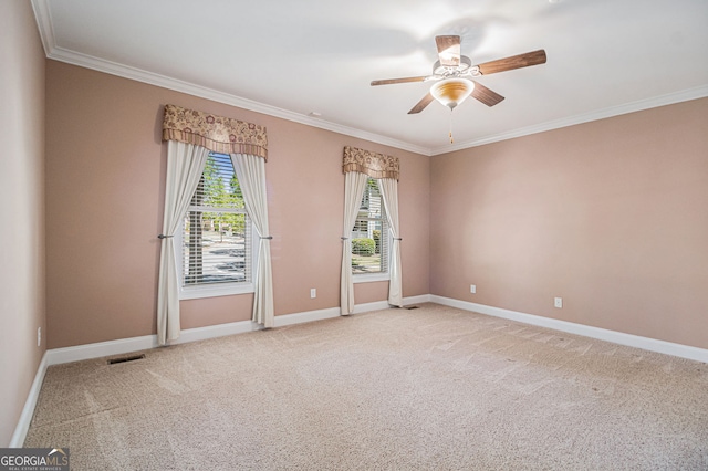 empty room with ornamental molding, ceiling fan, carpet flooring, and baseboards