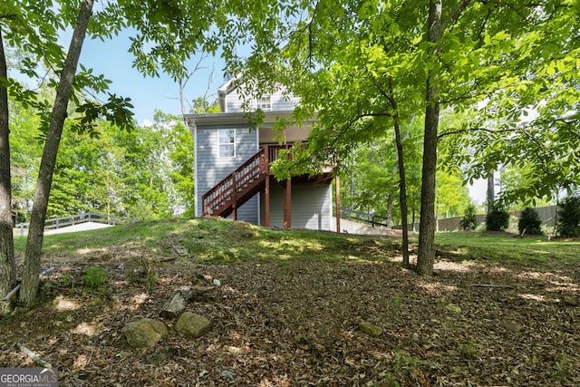 view of side of property with a yard and stairway