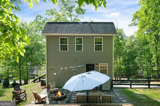 rear view of house featuring central AC, a patio area, a fire pit, and fence
