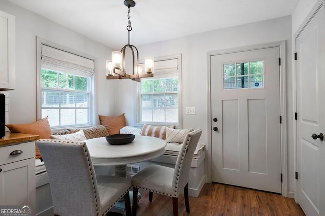 dining area featuring an inviting chandelier and wood finished floors