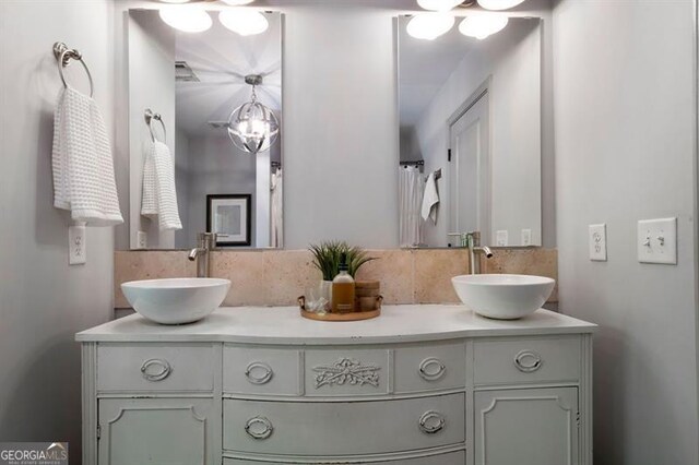 15 Swallow Dr, White, GA 30184 - bathroom featuring double vanity and backsplash