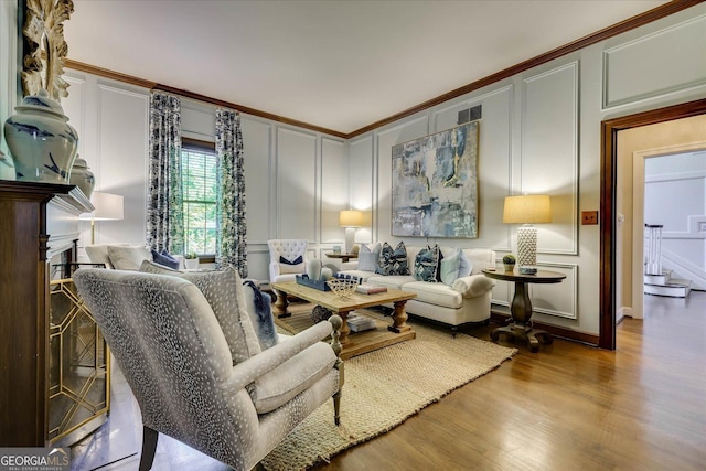 5 Prather Woods Ln, Augusta, GA 30909 - living area featuring a decorative wall, ornamental molding, and wood finished floors