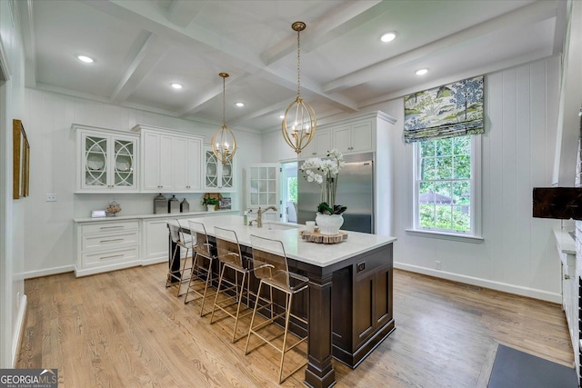 5 Prather Woods Ln, Augusta, GA 30909 - kitchen featuring light countertops, a breakfast bar, light wood-style floors, built in fridge, and white cabinetry