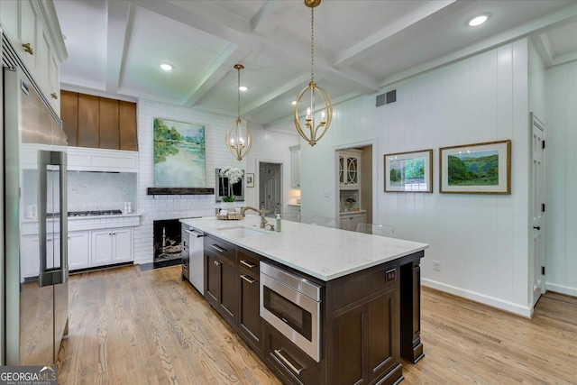 5 Prather Woods Ln, Augusta, GA 30909 - kitchen featuring a sink, visible vents, dark brown cabinetry, a notable chandelier, and built in appliances