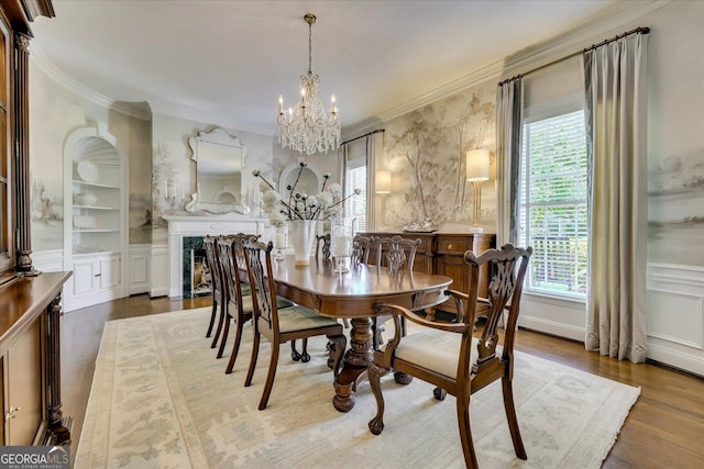5 Prather Woods Ln, Augusta, GA 30909 - dining room with a wainscoted wall, a notable chandelier, wood finished floors, a decorative wall, and ornamental molding