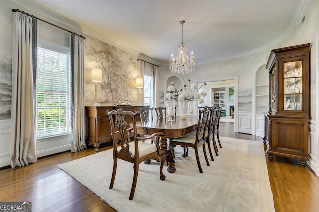 5 Prather Woods Ln, Augusta, GA 30909 - dining space with wood finished floors, an inviting chandelier, built in shelves, and ornamental molding