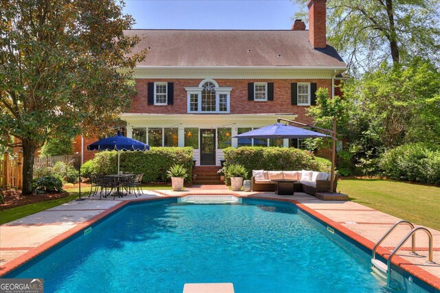 5 Prather Woods Ln, Augusta, GA 30909 - back of property featuring a chimney, outdoor lounge area, a patio, a fenced in pool, and brick siding