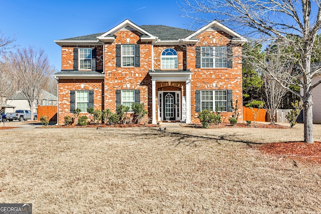 5447 Stirrup Way, Powder Springs, GA 30127 - colonial-style house featuring fence, brick siding, and roof with shingles