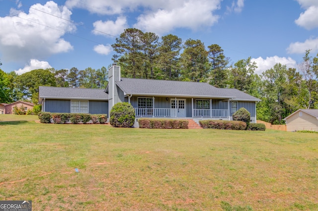single story home featuring board and batten siding, a front yard, a porch, and a chimney
