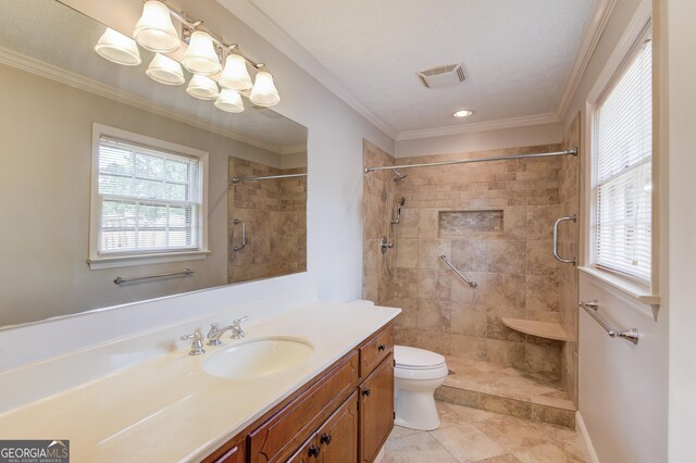 full bathroom featuring a tile shower, visible vents, toilet, and a wealth of natural light