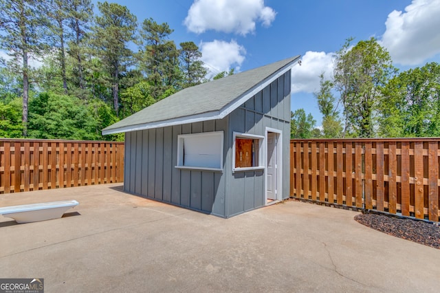 view of outbuilding with an outbuilding and fence