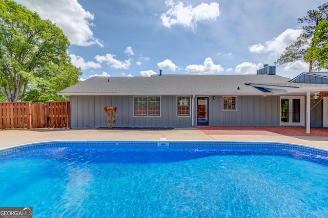 view of pool with a gate, a patio area, french doors, fence, and a fenced in pool