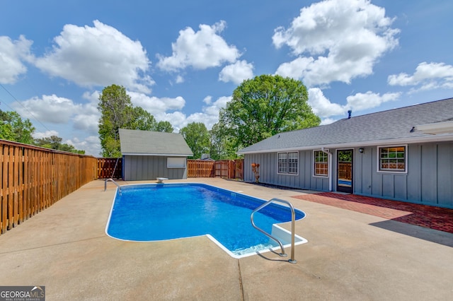 view of pool featuring a storage shed, a fenced in pool, an outbuilding, a fenced backyard, and a patio area