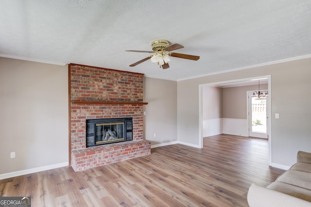 unfurnished living room with baseboards, a ceiling fan, wood finished floors, and a textured ceiling