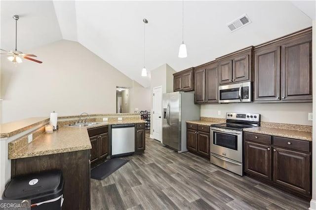 kitchen with ceiling fan, appliances with stainless steel finishes, a sink, vaulted ceiling, and visible vents