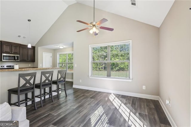 living room with a ceiling fan, visible vents, dark wood finished floors, baseboards, and high vaulted ceiling